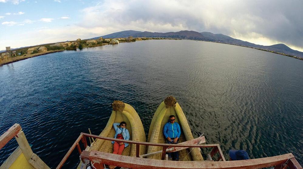 two people in a boat on a body of water at LAKE TITICACA LODGE in Puno