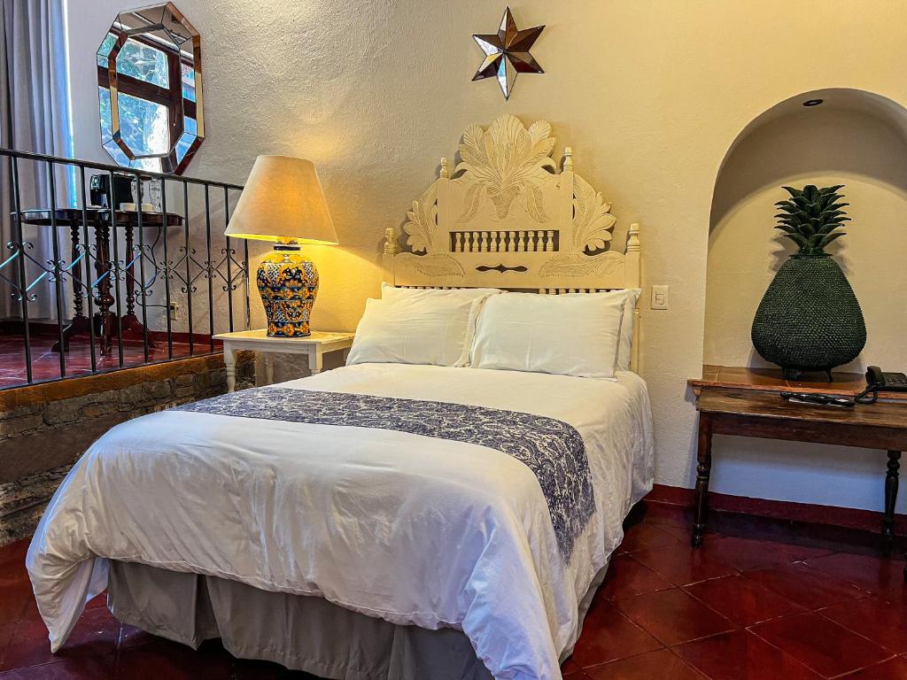 Postel nebo postele na pokoji v ubytování Hacienda de las Flores