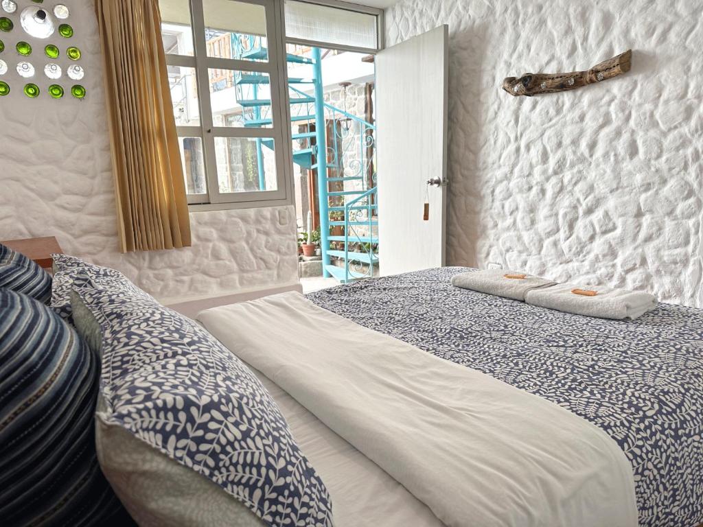 a bedroom with a large bed with pillows on it at Homestay Pachamama in Cabanaconde