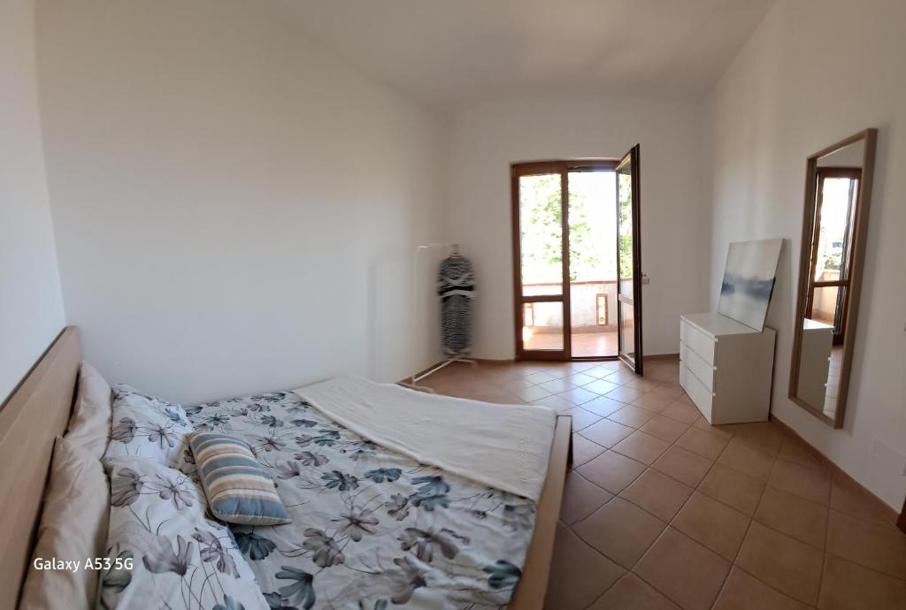 a bedroom with a bed and a mirror at La casa di là. in San Donato