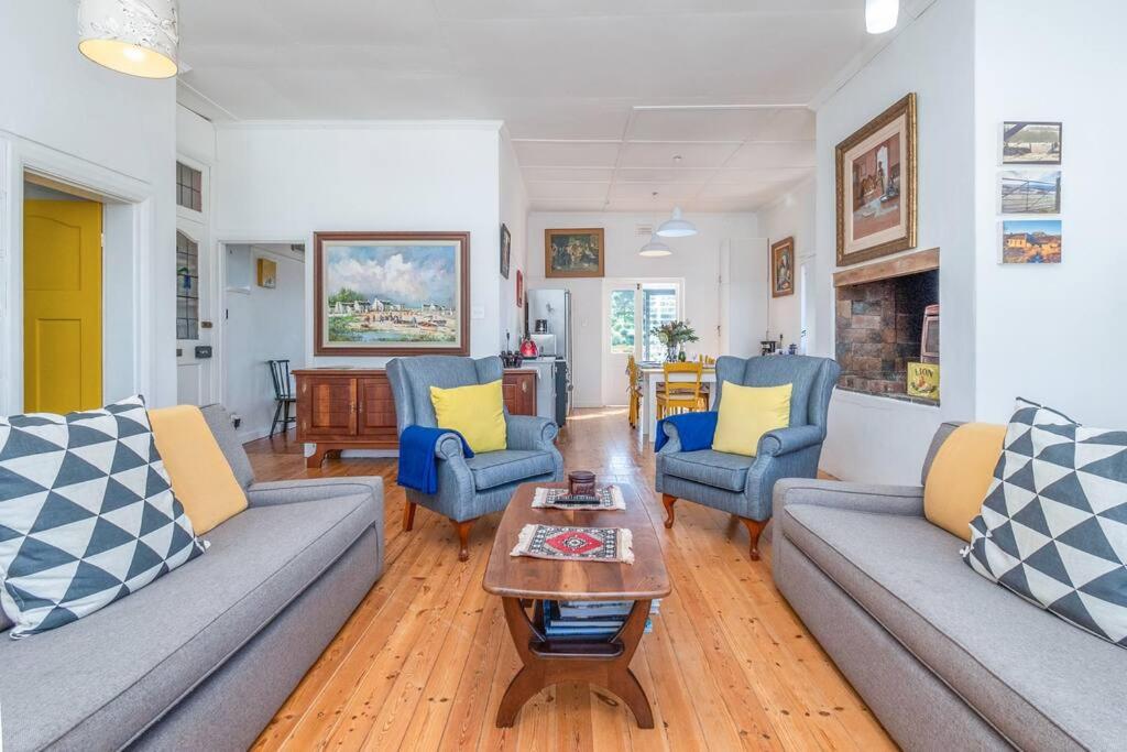 a living room with couches and a coffee table at Vintage Charm in Tamboerskloof in Cape Town