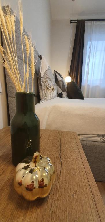 a donut sitting on a table next to a vase at Julia's home in TÄƒuÅ£ii MÄƒgheruÅŸ
