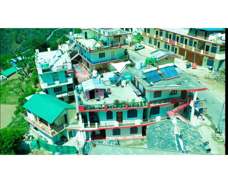 an overhead view of a large building with blue at Hotel Jagatguru, Barkot in Barkot