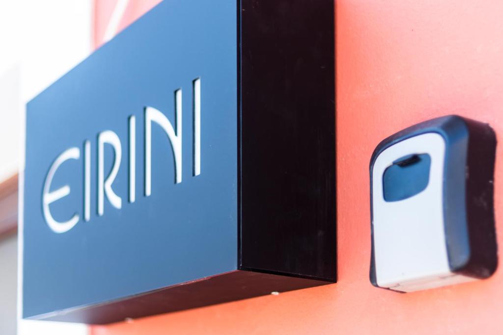 a sign for an iphone on a wall at EIRINI in Symi