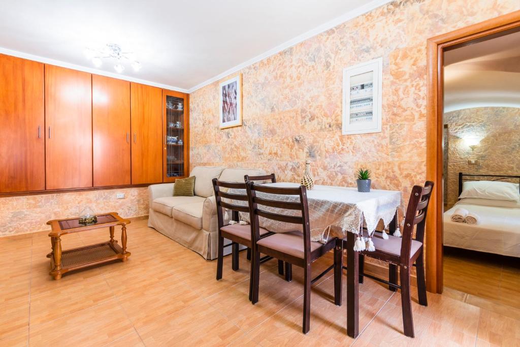 a dining room with a table and a couch at EIRINI in Symi