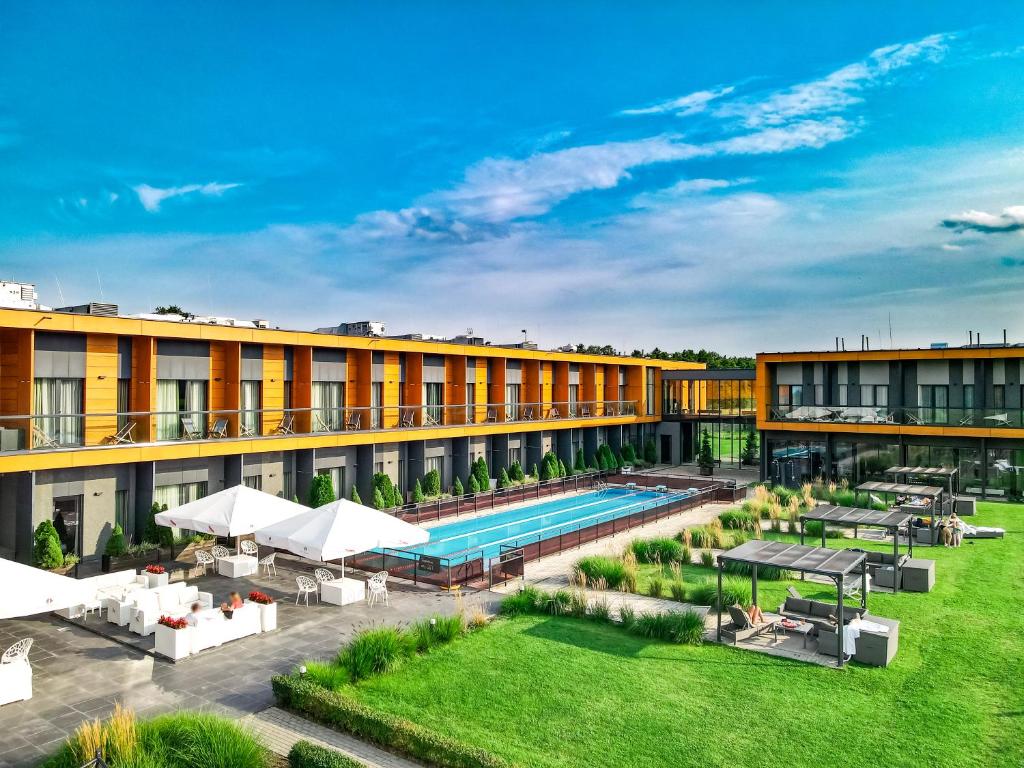 an image of the courtyard of a hotel with a swimming pool at Hotel Bonifacio SPA&SPORT Resort in Sochocin