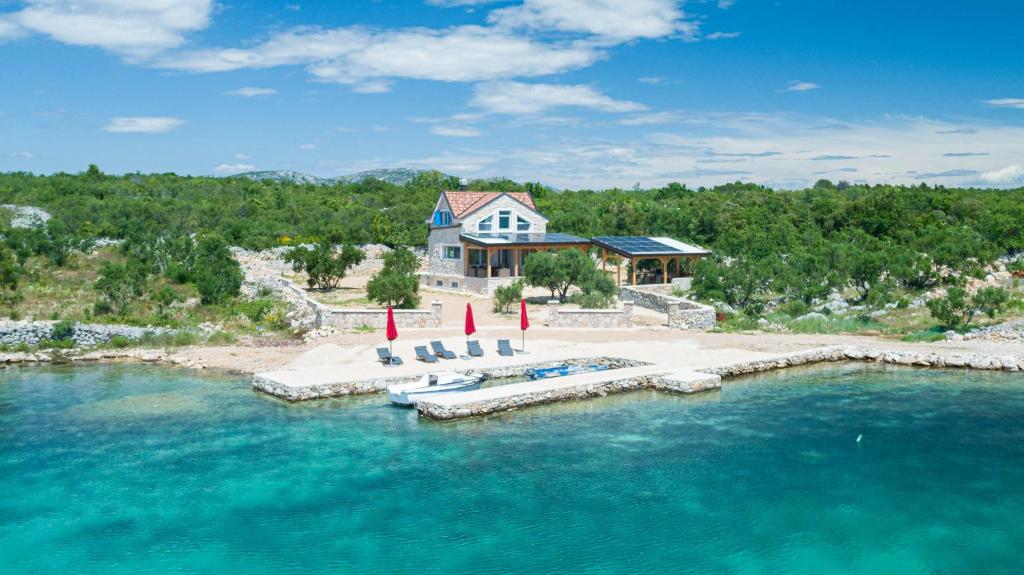 an aerial view of a house on an island in the water at Villa Maris in Betina