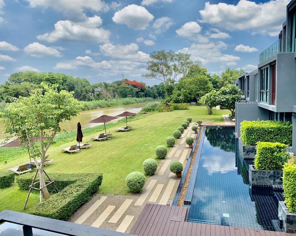 an aerial view of a resort with a swimming pool at Zensala Riverpark Resort-SHA Extra Plus in Chiang Mai