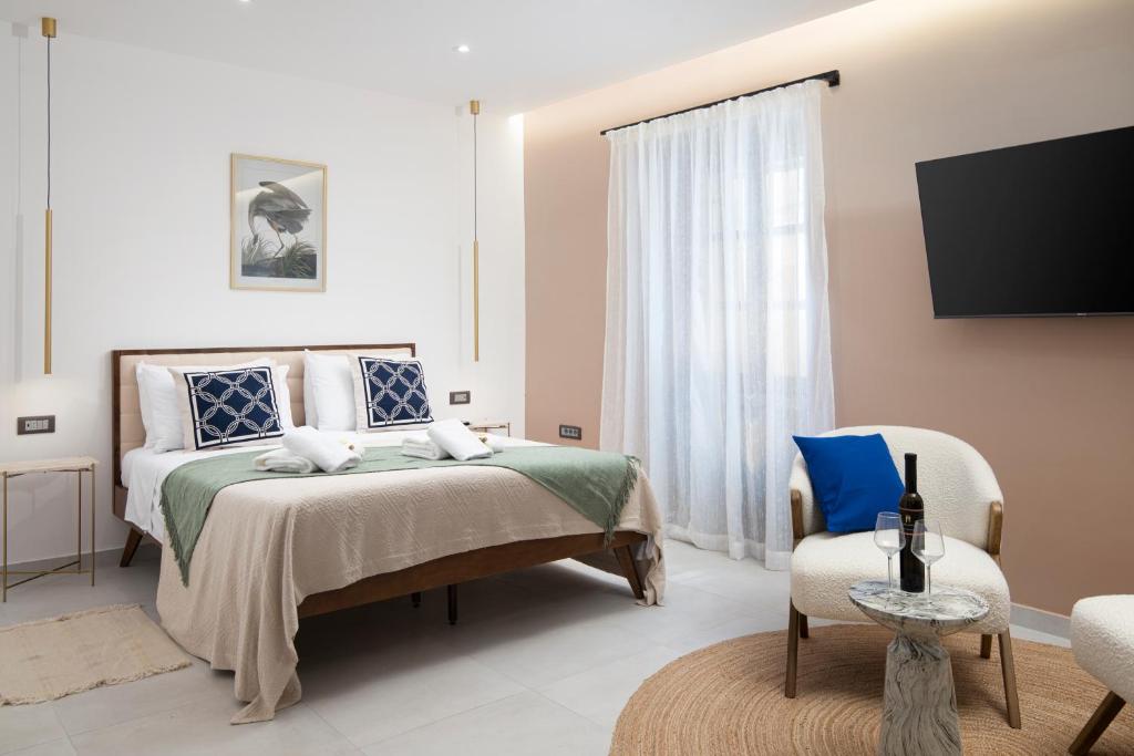 a bedroom with a bed and a flat screen tv at Twins Amphitheatre Apartments in Pula