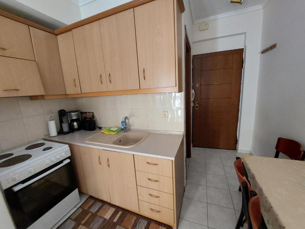 a small kitchen with a sink and a stove at KLEOPATRA APARTMENT in Neoi Epivates