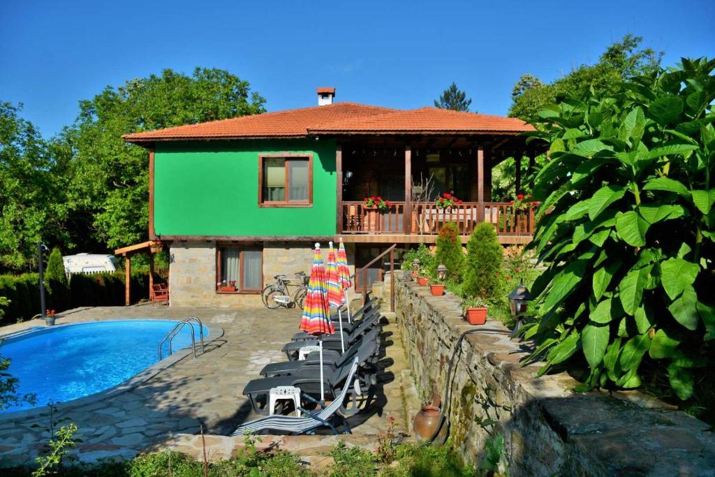 a house with a swimming pool in front of it at Къща край реката/ House by the river in Vetrintsi