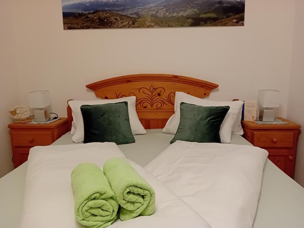 a bedroom with two beds with green towels on them at Much`s Bergstüberl in Wattenberg