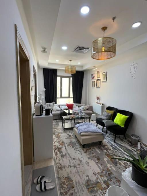 een woonkamer met een bank en een tafel bij A journey of luxury Seaview living. in Koeweit