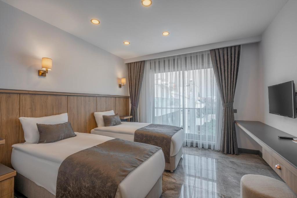 Postel nebo postele na pokoji v ubytování Quality Gold Suite Hotel