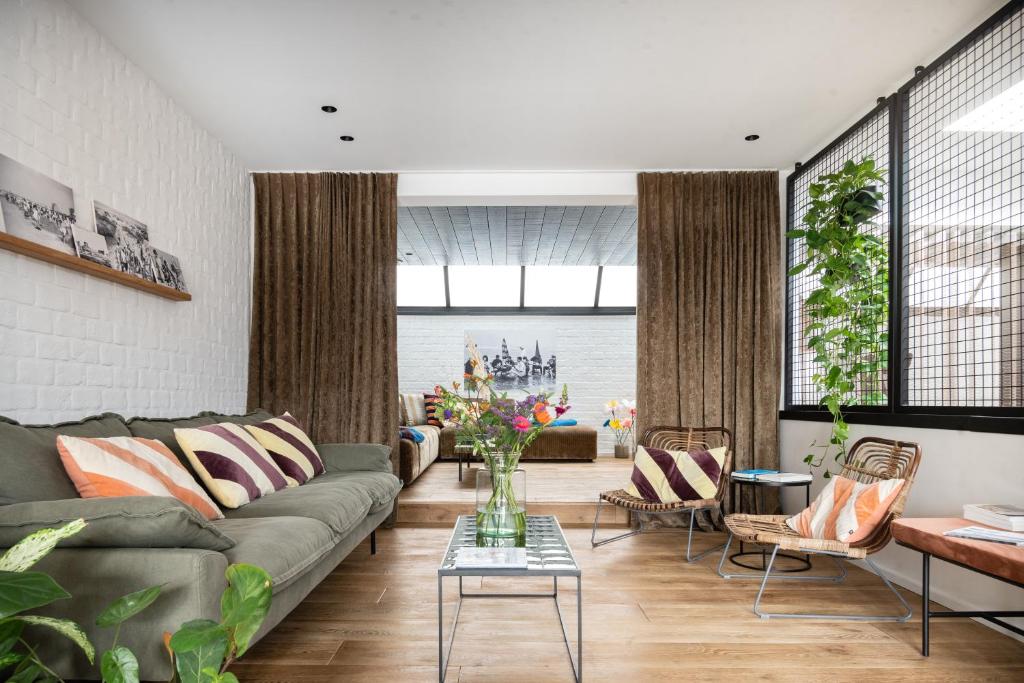 a living room with a couch and a table at WOWieGermain Luxueus vakantiehuis voor families, vlak bij het strand in Oostduinkerke