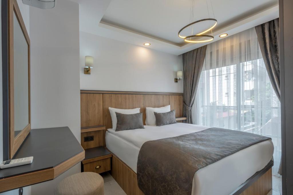 Postel nebo postele na pokoji v ubytování Quality Gold Suite Hotel