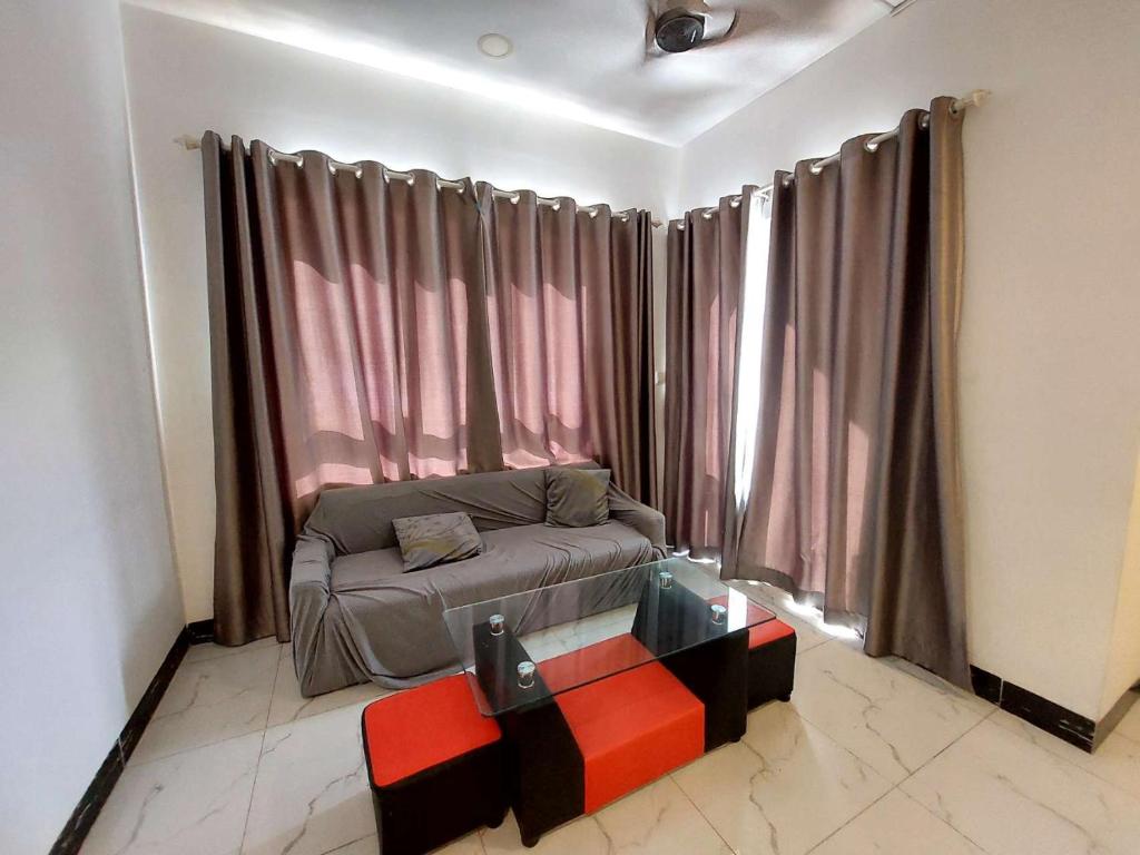 a living room with a couch in front of a window at Residence L two bedroom in Phnom Penh