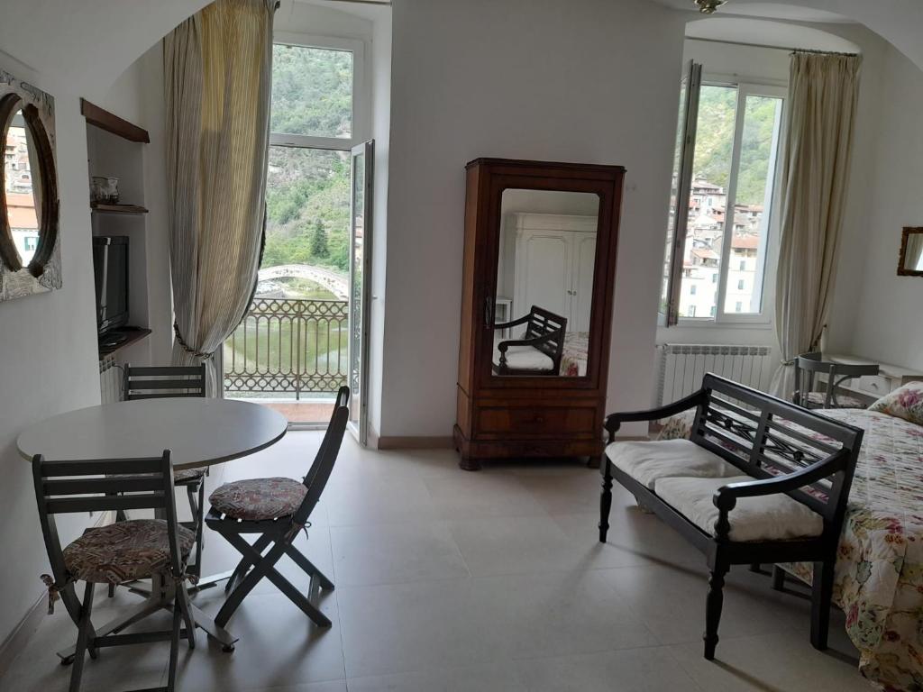 a living room with a table and chairs and a mirror at Bellavista in Dolceacqua