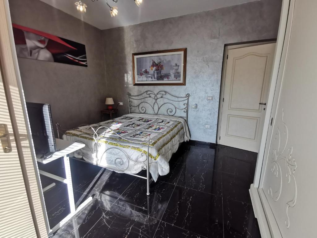 a bedroom with a bed in the corner of a room at La Luna's Home in Lanciano