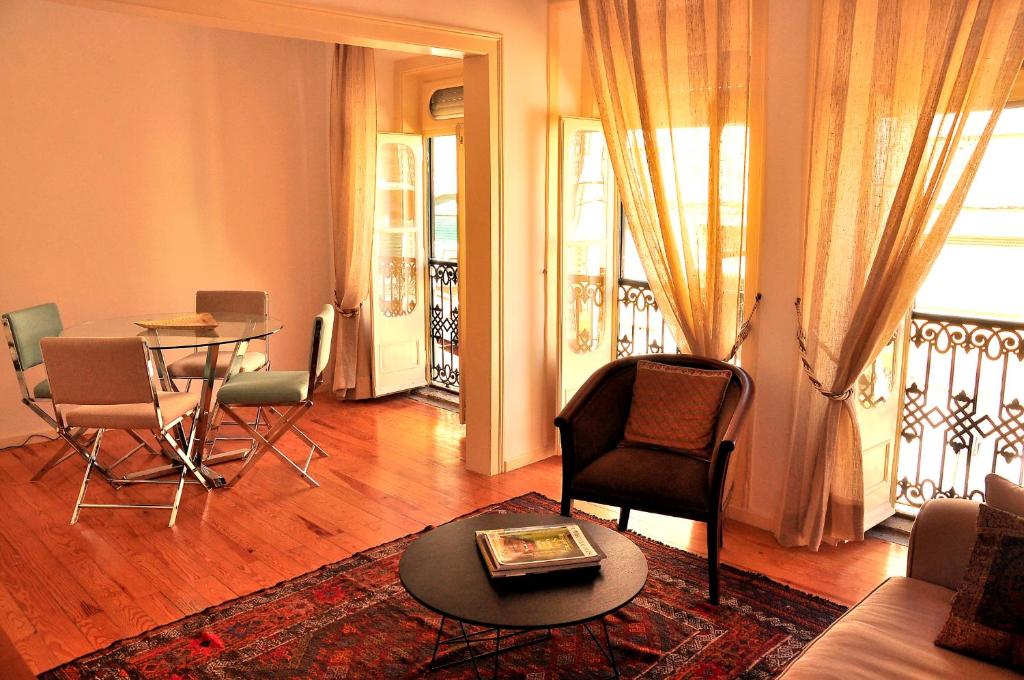 リスボンにあるLapa Chic Apartment by be@homeのリビングルーム(テーブル、椅子付)