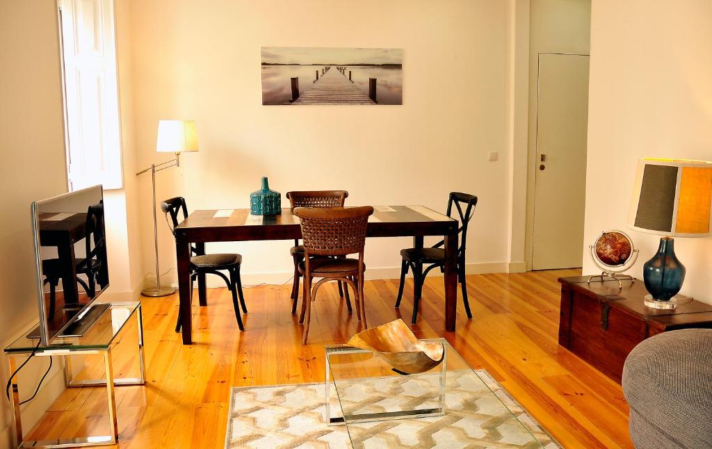 a living room with a dining room table with chairs at Marques Classy Apartment by be@home in Lisbon