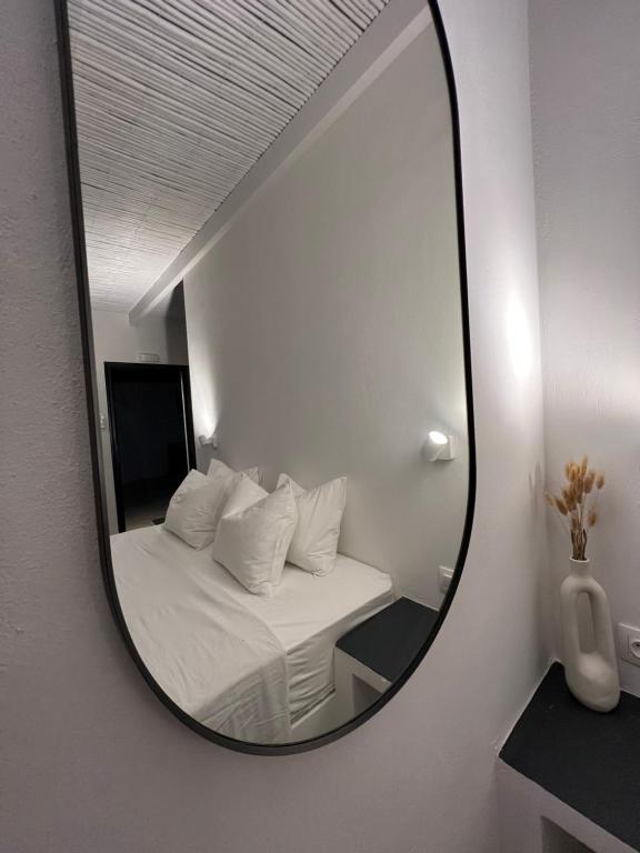 a mirror reflection of a bed in a room at Vie rêvée luxury suites in Ganema