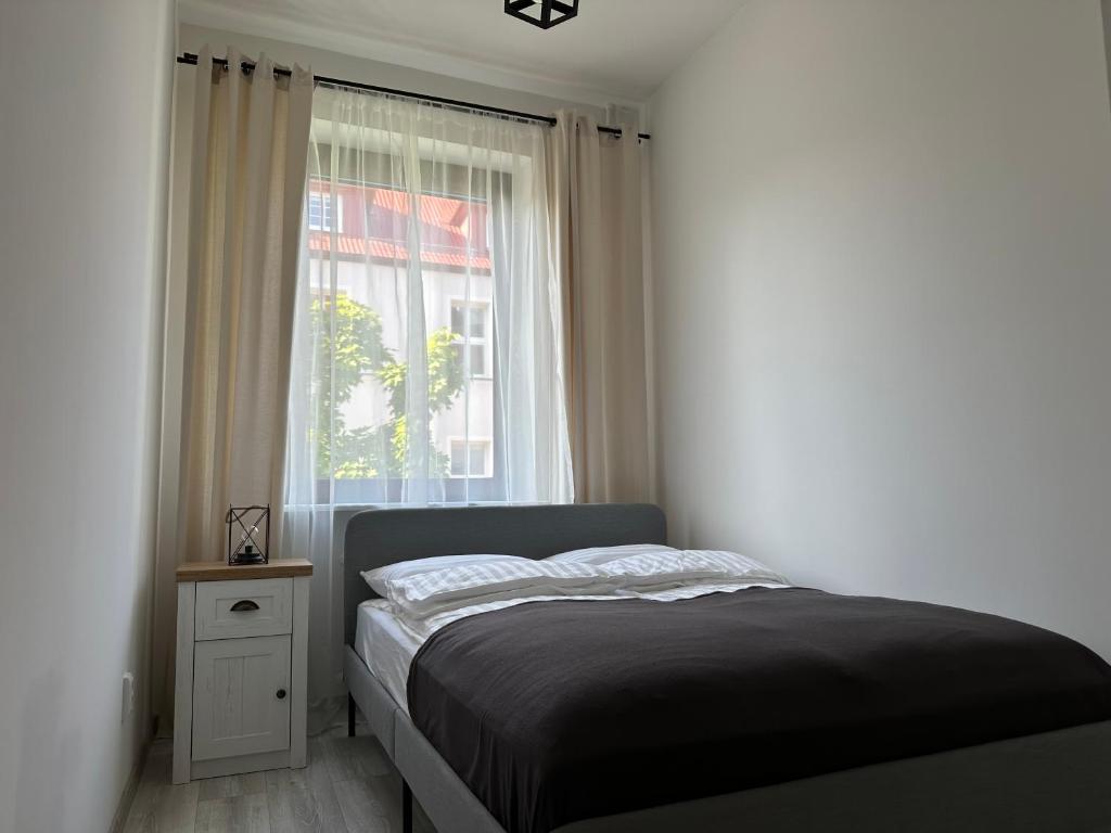 Postel nebo postele na pokoji v ubytování Apartamenty Przy Deptaku