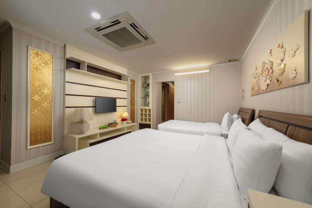 Postel nebo postele na pokoji v ubytování HALO HANOI HOTEL