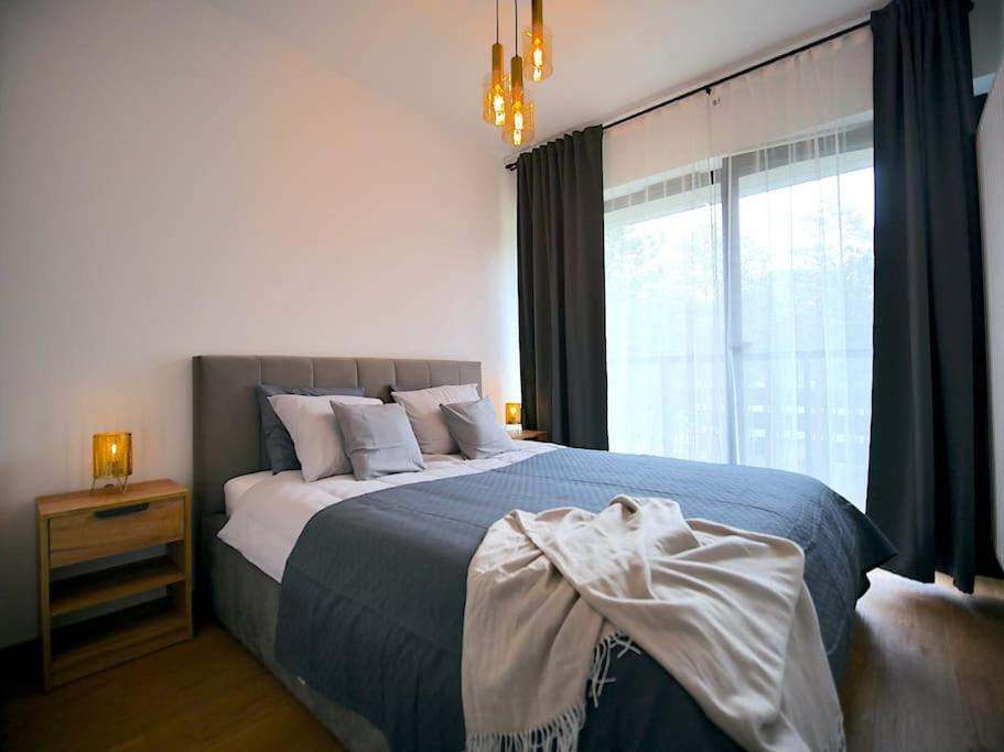 a bedroom with a large bed and a window at Rogowo 117J Shellter Apartments in Rogowo