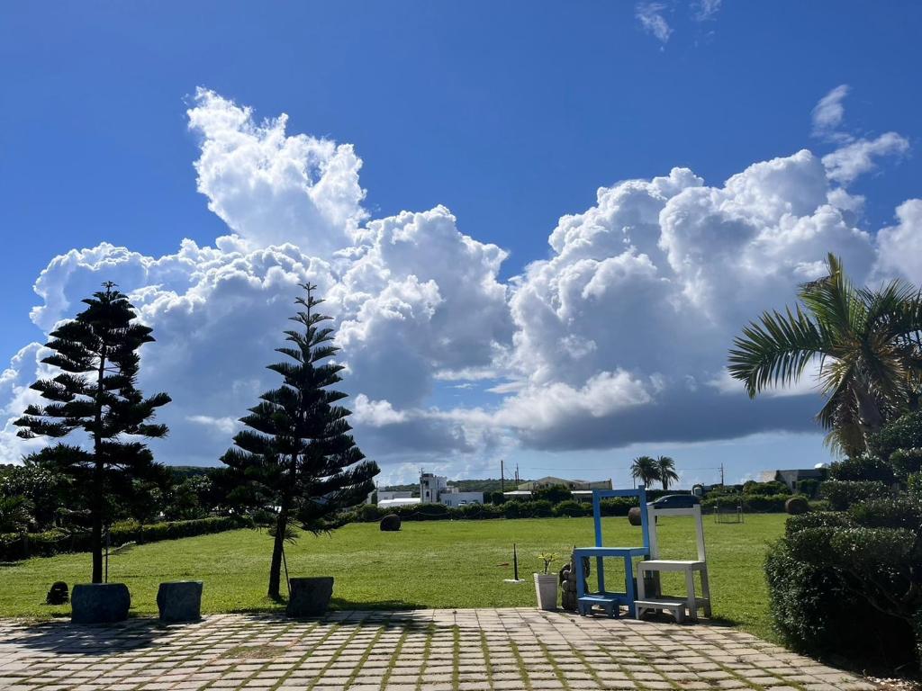 a park with a bench and a palm tree at Kenting Summerland Garden Resort in Eluan