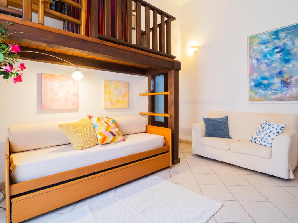 a bedroom with a bunk bed and a chair at Casa Maretta in Cagliari