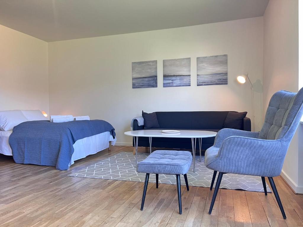 a bedroom with a bed and a table and chairs at Nice Apartment In Rdovre Close To The Highway in Rødovre