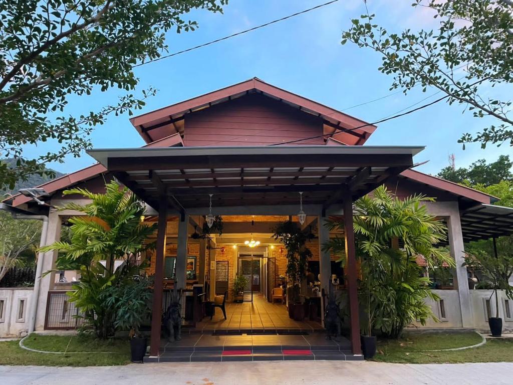 a house with a gambrel roof at Pangkor Nature View House in Pangkor