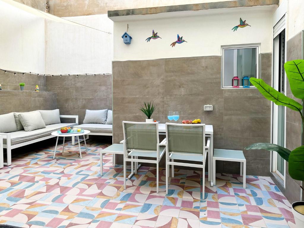 a patio with a table and chairs on a colorful floor at Capitan Rueda Apartments Alicante - Parking 10 euros per day in Alicante