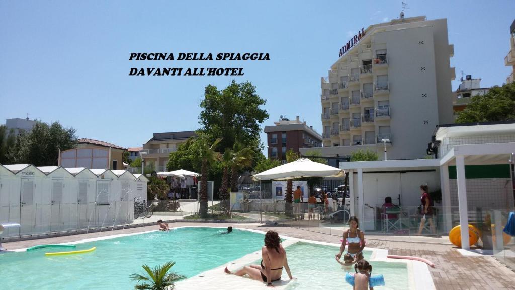 a group of people sitting in a swimming pool at Hotel Admiral - on the beach in Riccione