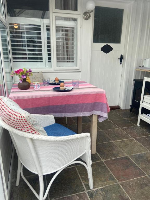 a table with a table cloth and chairs in a kitchen at Barrow Harbour studio apartment in Tralee