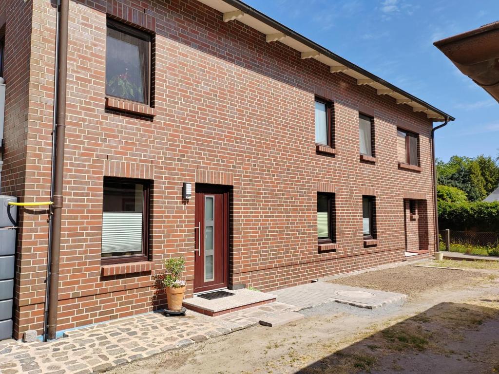 a brick house with a potted plant in front of it at Rügen Fewo 303 in Gingst