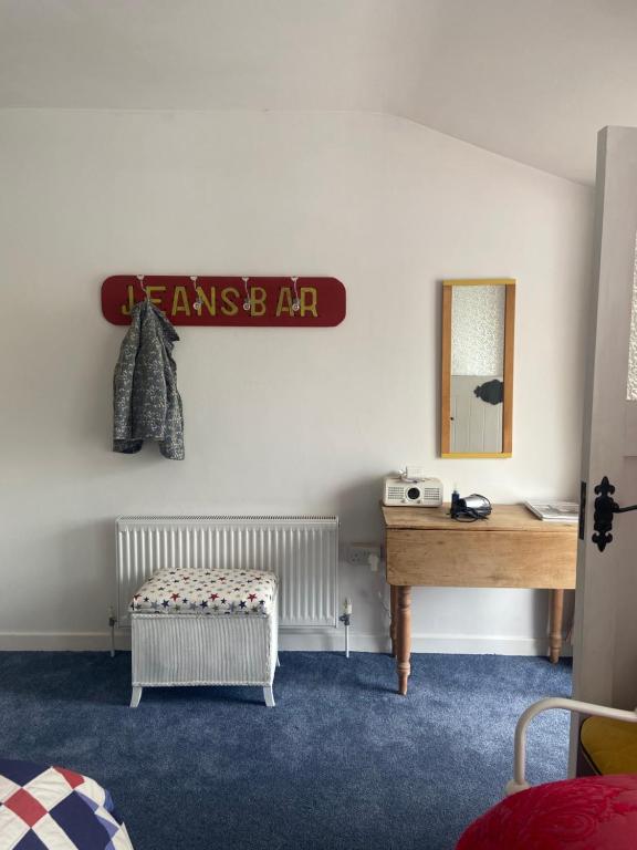 a room with a table and a mirror and a drawer at Barrow Harbour studio apartment in Tralee