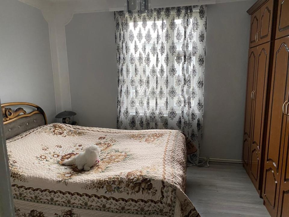 a stuffed animal sitting on a bed in a bedroom at Отдых в Ташире in Vorontsovka