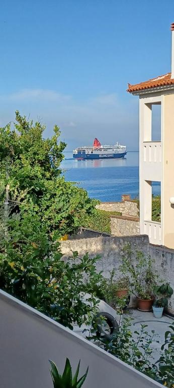 a large ship in the water with a building at Seaview Luxury Apartment in Mytilini