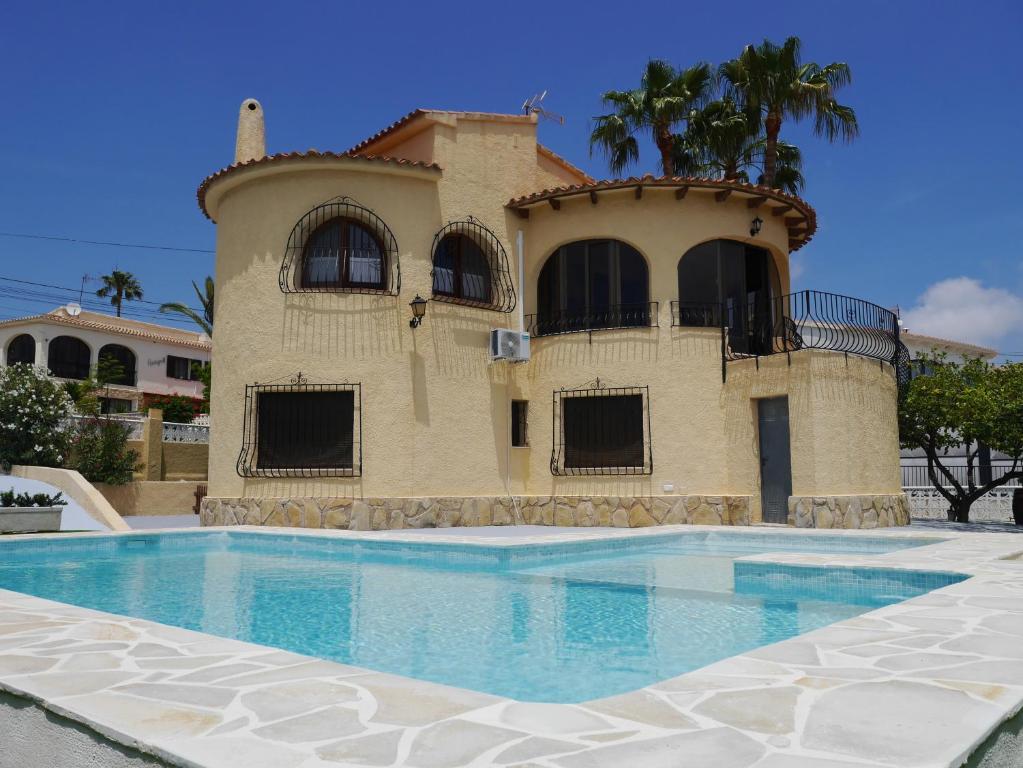 a house with a swimming pool in front of a building at Llar Soraya - Chalet en Calpe in Calpe