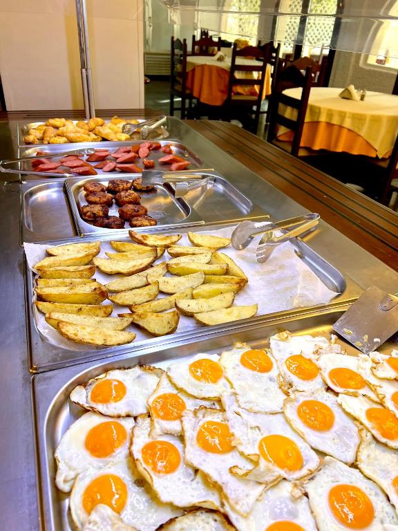 a buffet with eggs and other food on a table at Karteros Hotel in Karteros