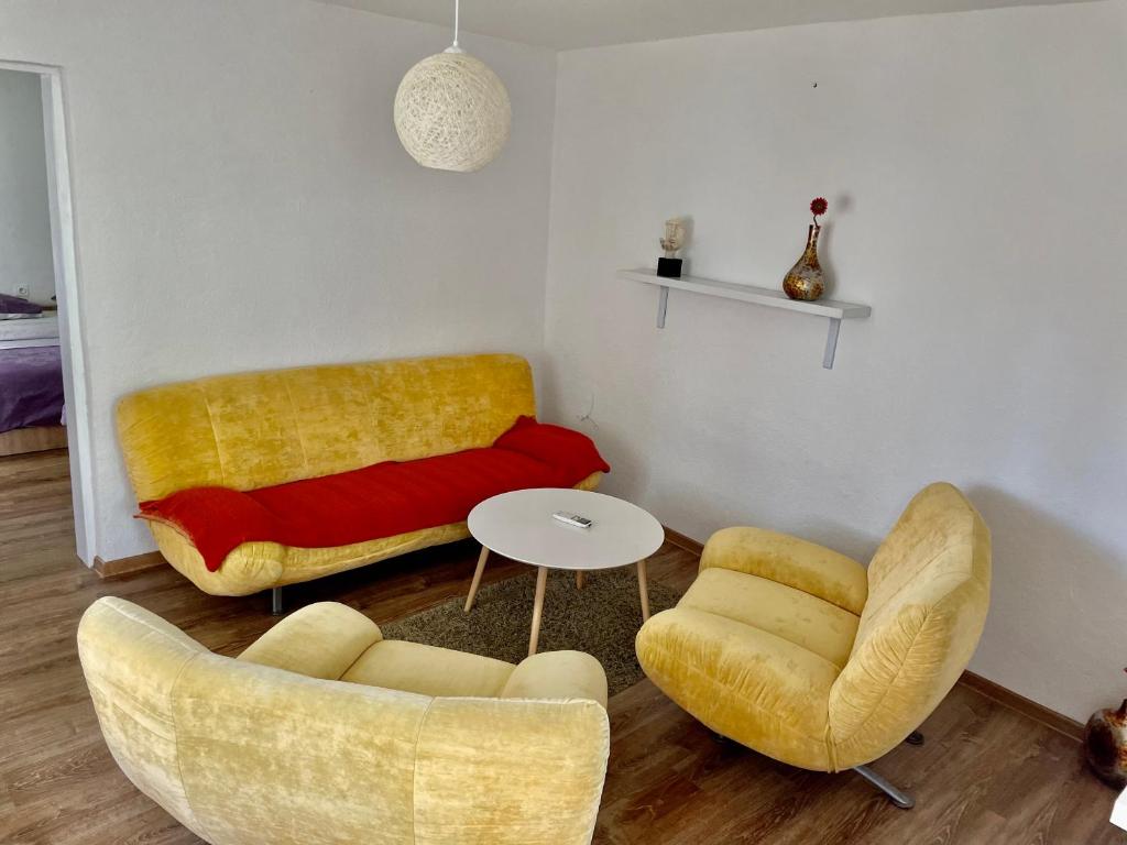 a living room with a couch and a table and chairs at Apartment Stolac in Stolac