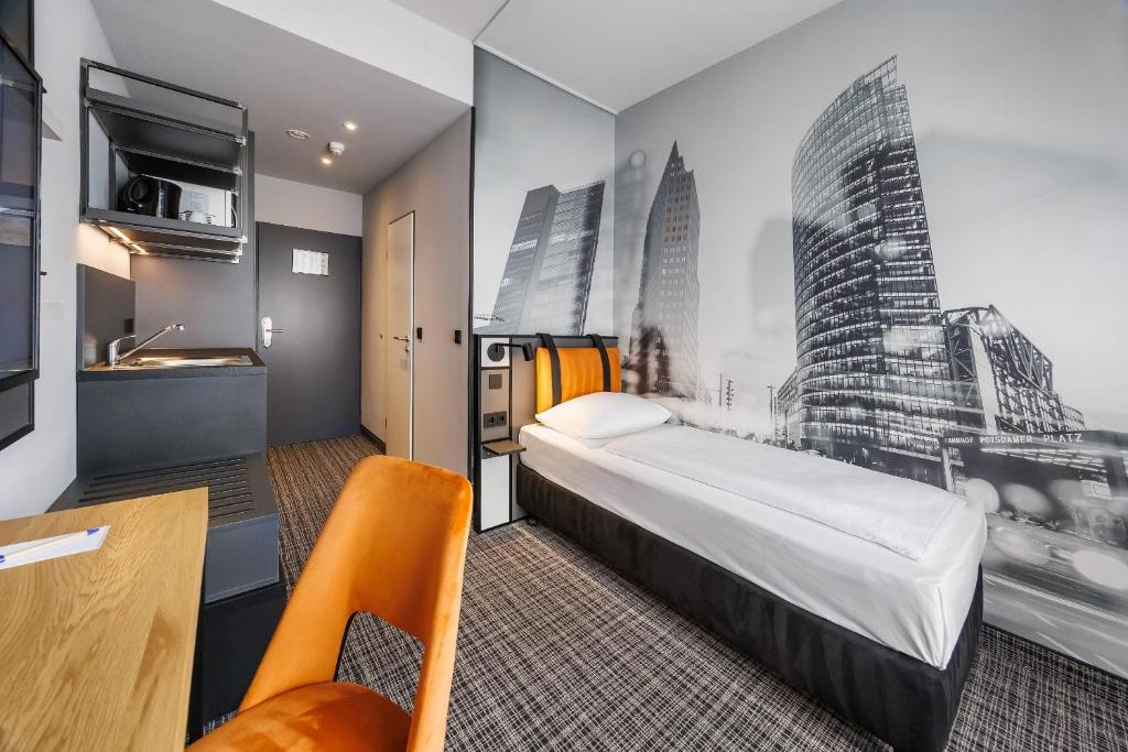 a hotel room with a large bed and a desk at Hotel Lützow in Berlin