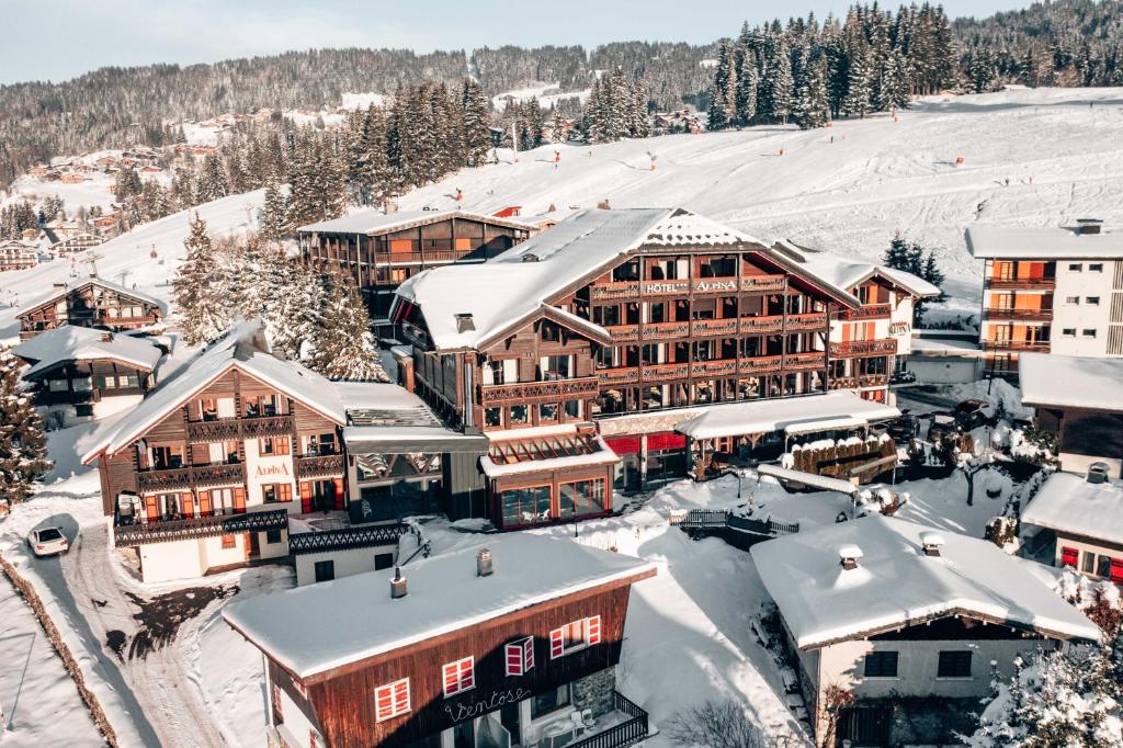 an aerial view of a ski resort with snow covered buildings at Hôtel Alpina &amp; SPA in Les Gets