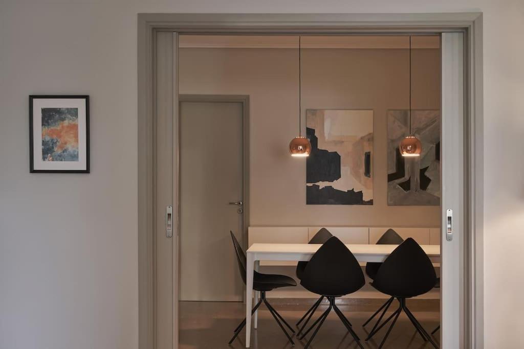 a dining room with a table and chairs at Chic designer home next - Hilton in Athens