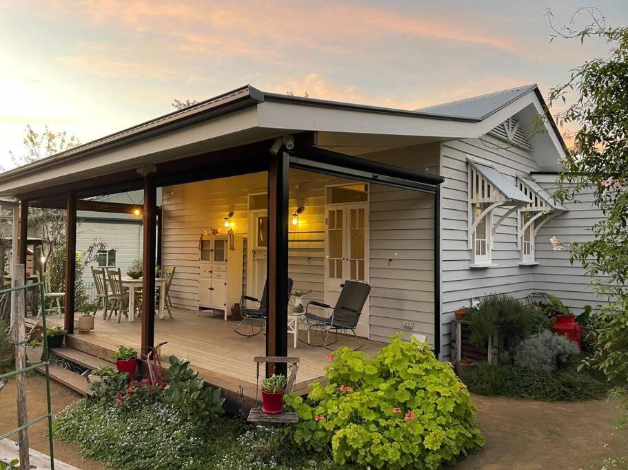 a small house with a porch and a deck at The Rustic Cottage - Canungra in Canungra