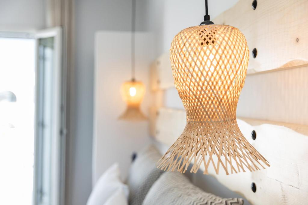 a light fixture hanging over a couch in a room at Naxos Leisure in Agios Prokopios