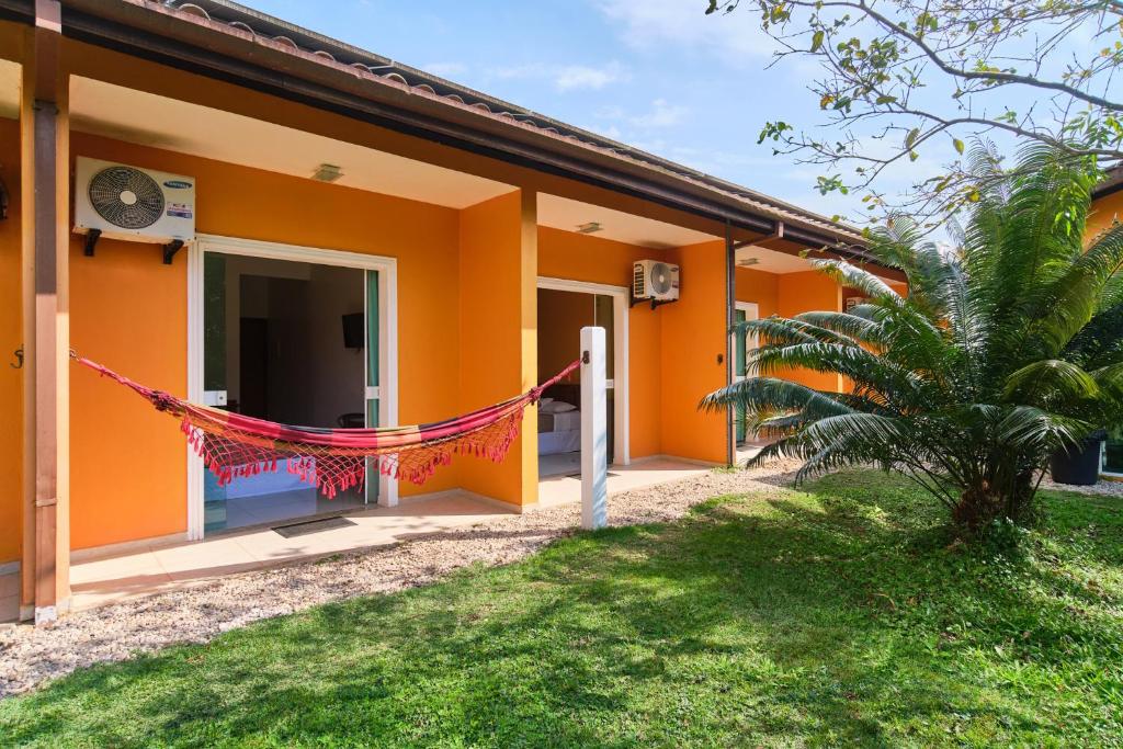 an orange house with a red string in front of it at Pousada Villa Piemonte in Ubatuba