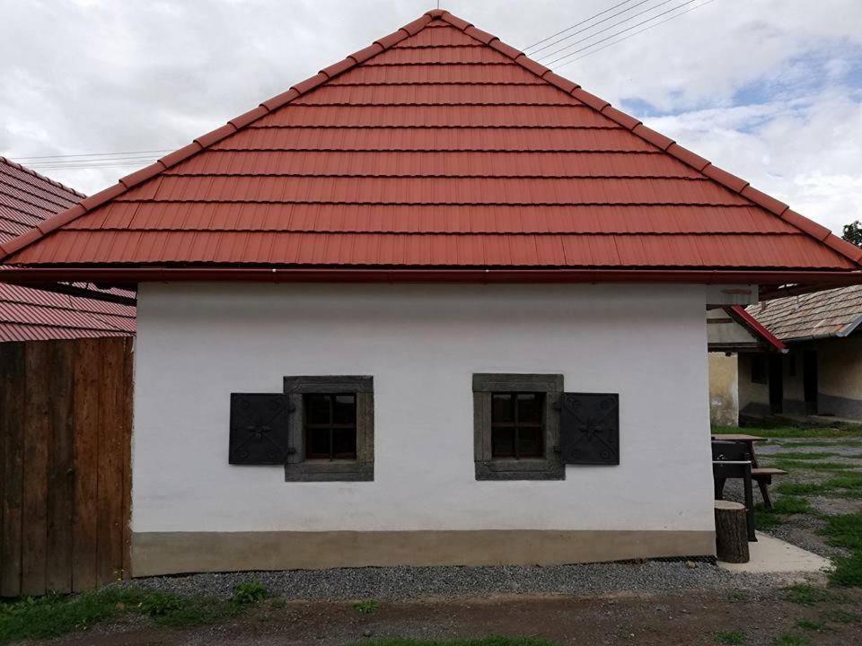 a white building with a red roof with windows at Chyžka Stará Hora in Sebechleby